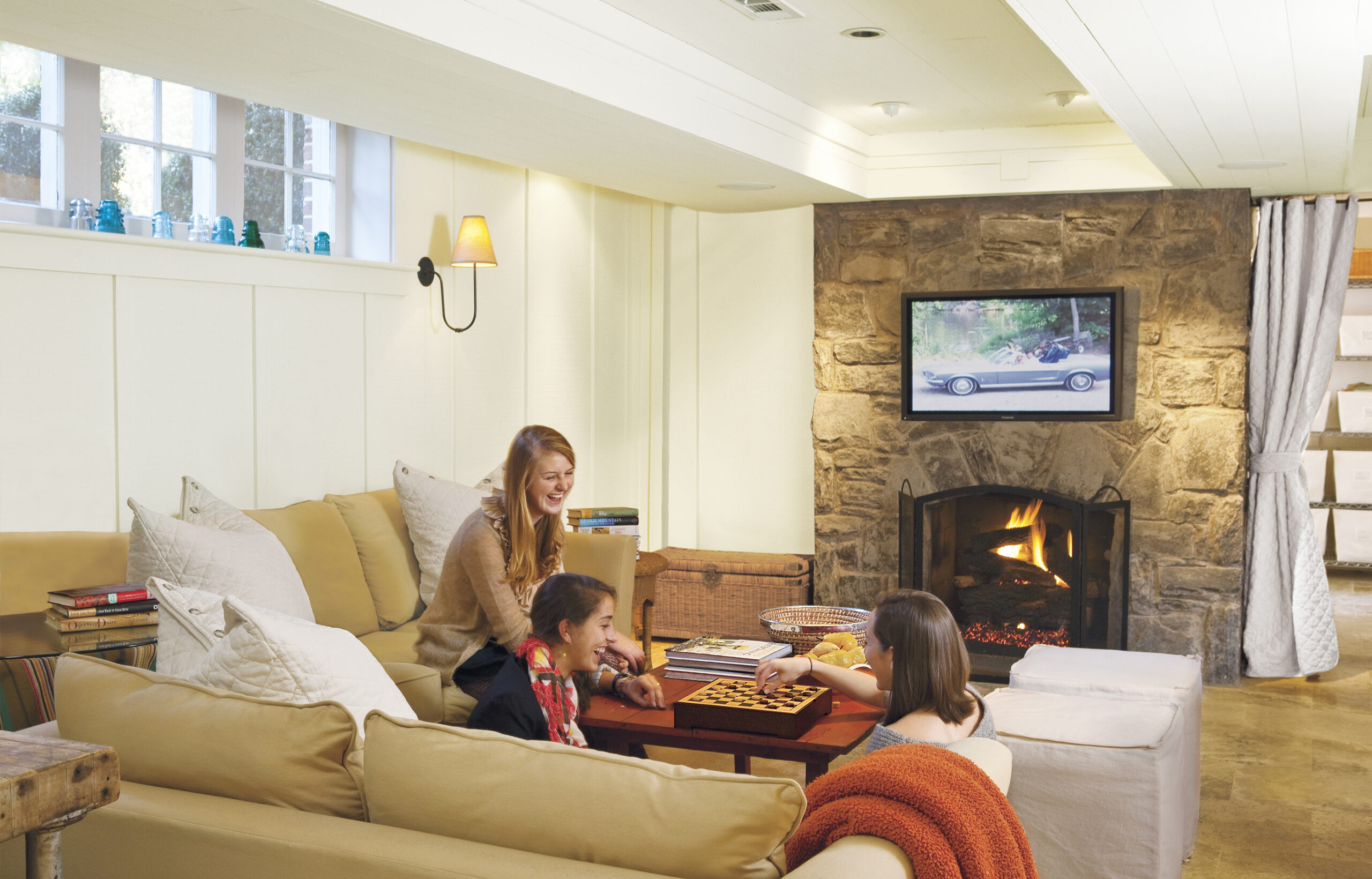 Three women playing games and spending time in the basement.