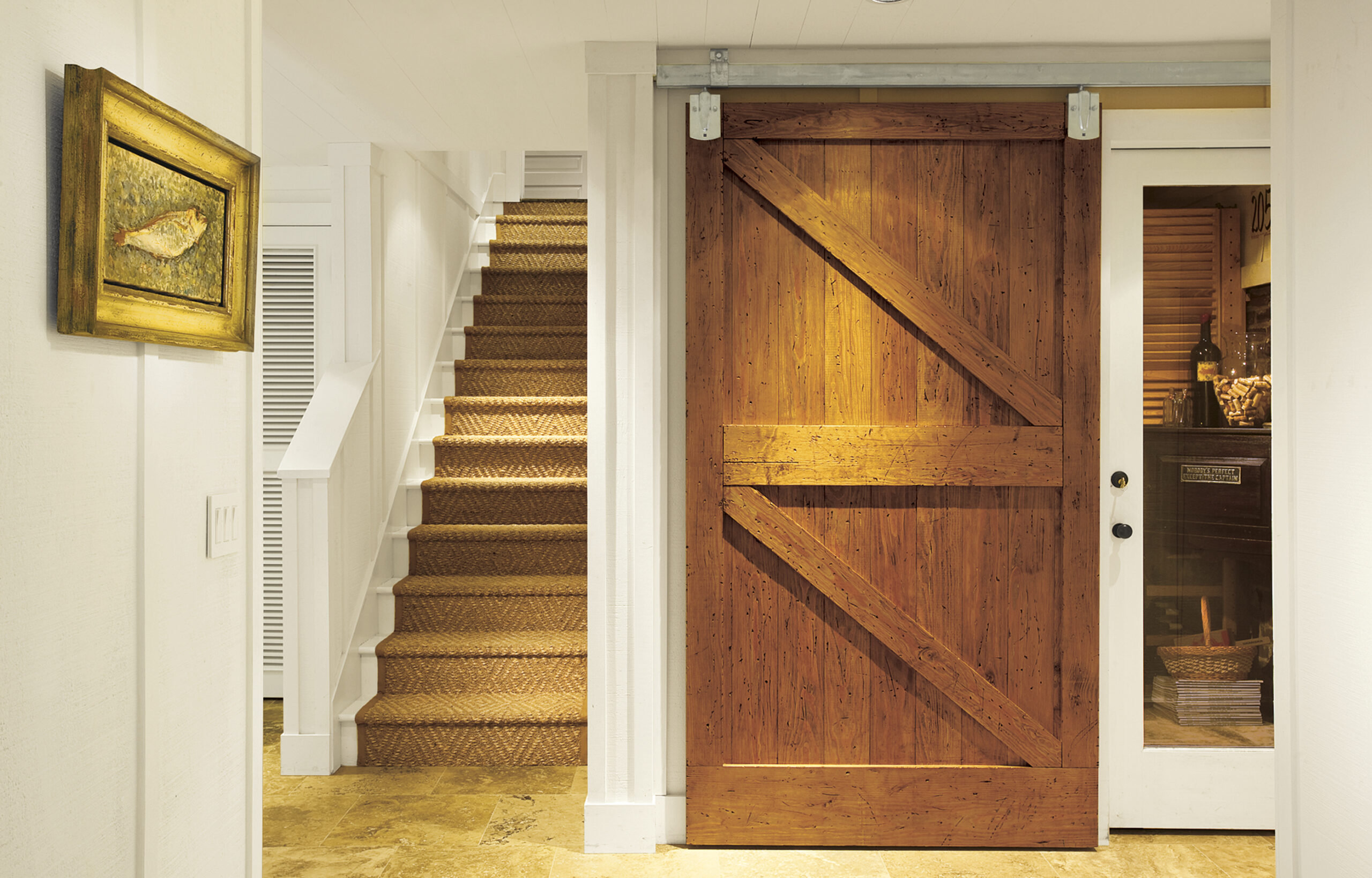 Basement rooms divided by a sliding barn door.