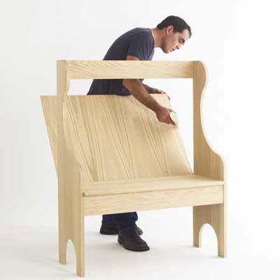 Man assembling wooden bench set.