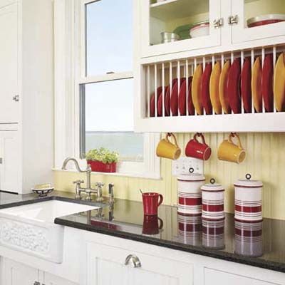 Plate display rack insert organizing dishes in kitchen cabinet.