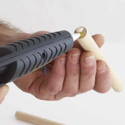 Applying wood glue in wine rack construction.