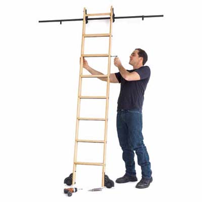 Man assembling a rolling ladder.