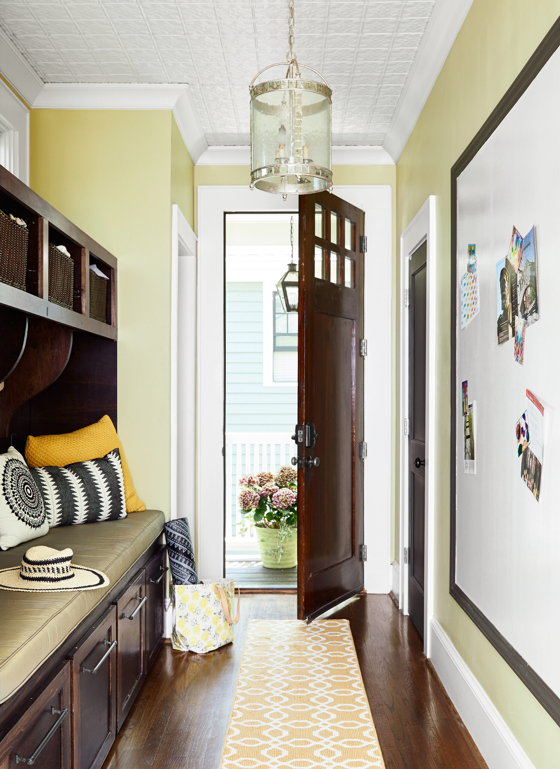 An open door leading to the mudroom area with built-in storage.