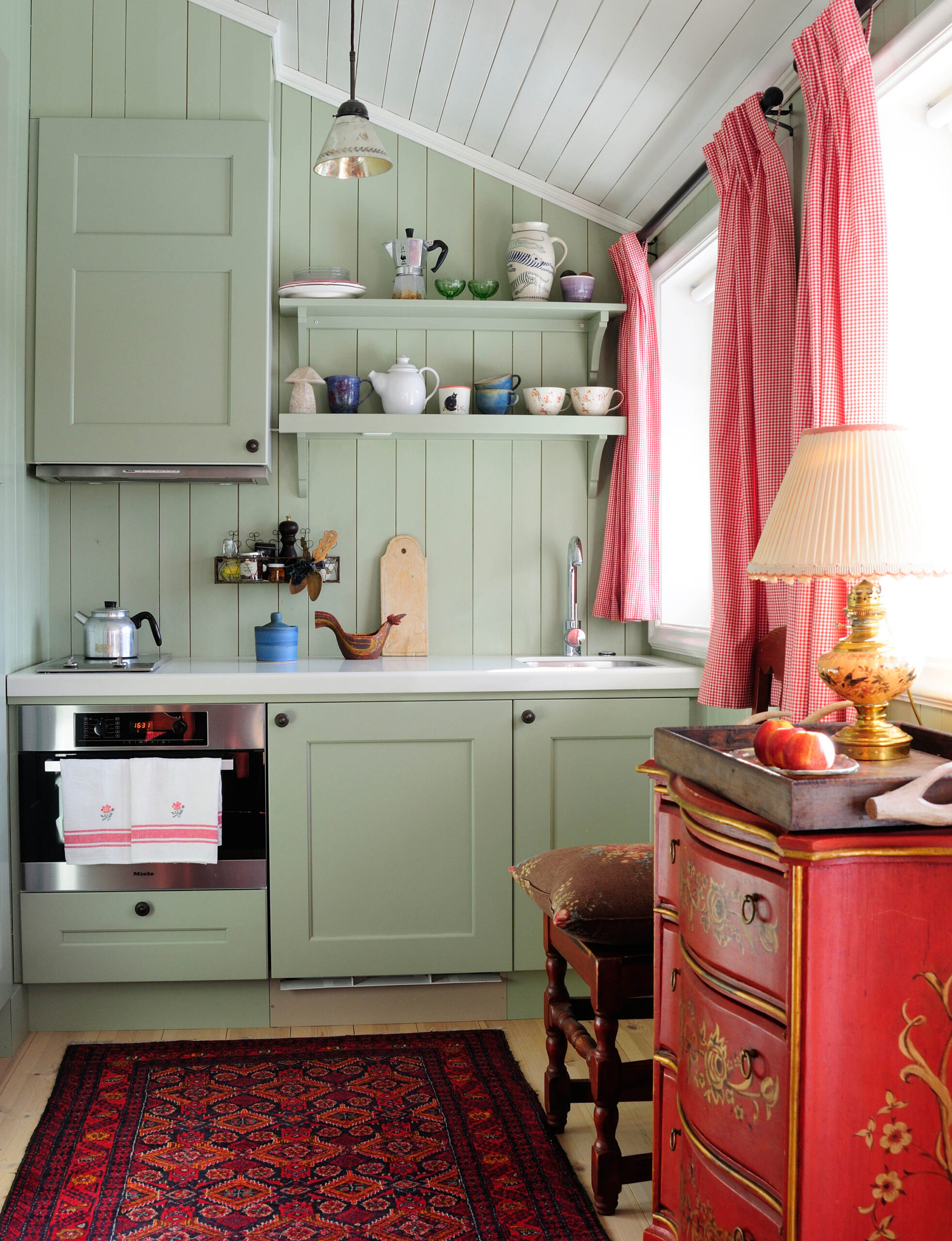 A kitchen painted green and white.