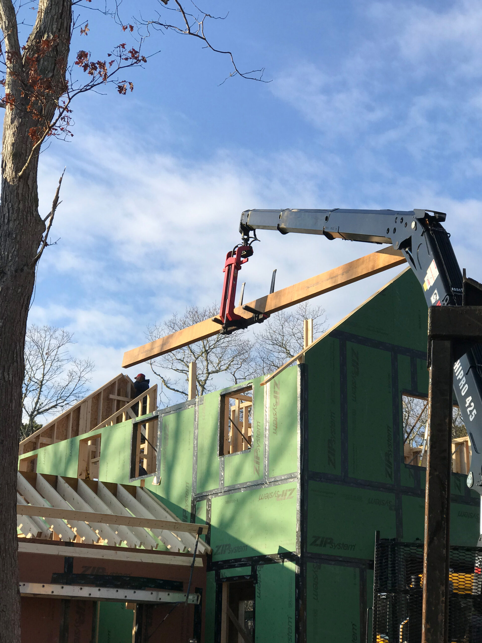 A large beam being installed in the house.