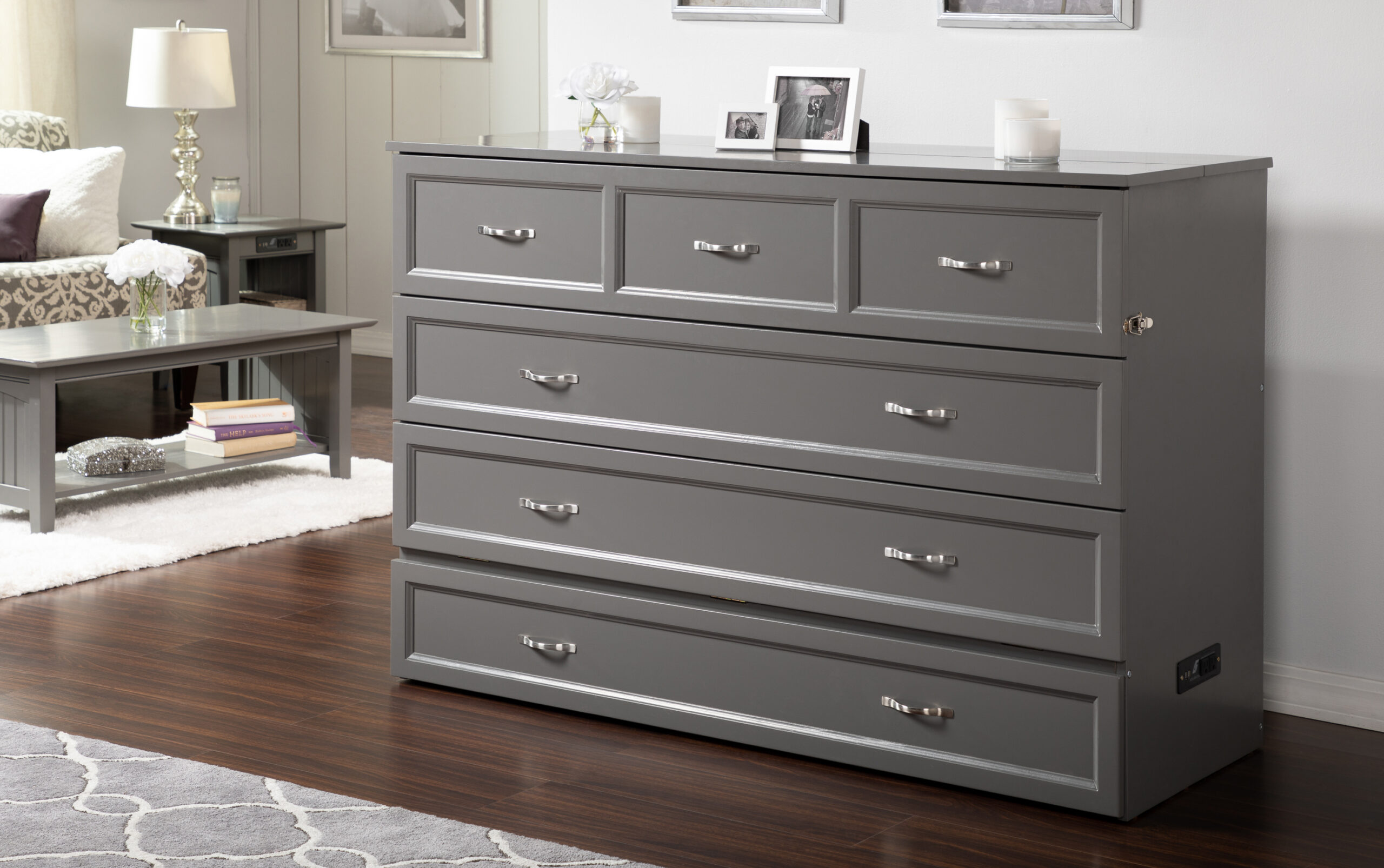 A murphy bed in a chest with drawers.