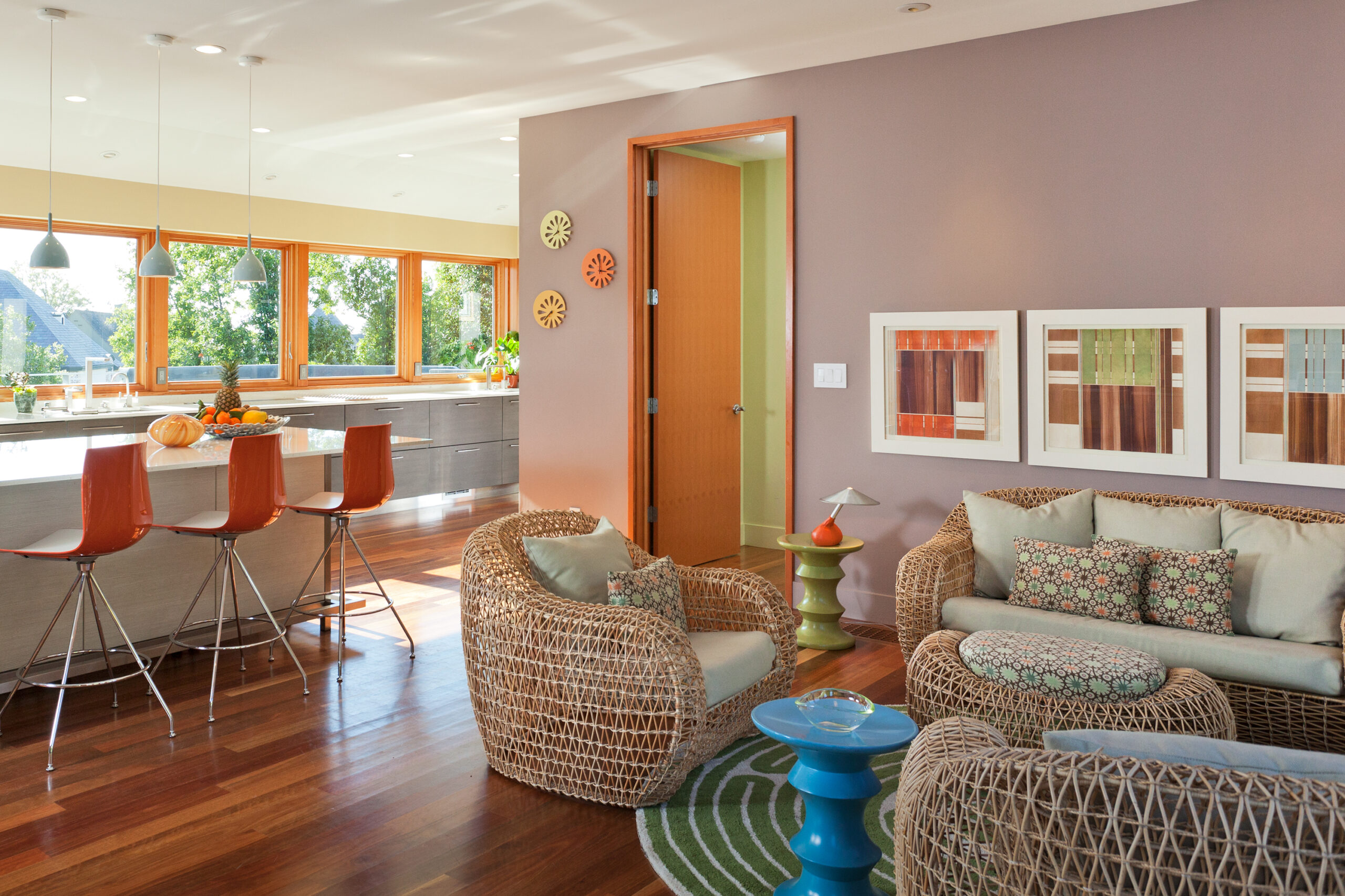 A kitchen and sitting room with a yellow-orange color scheme.